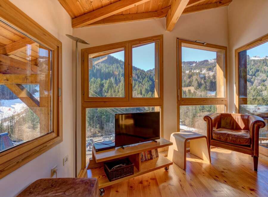 Experience the charm of this stunning property, featuring a cozy living area with breathtaking mountain views.