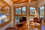 Experience the charm of this stunning property, featuring a cozy living area with breathtaking mountain views.