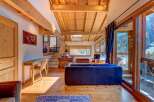 Experience the charm of this stunning property, featuring a warm wooden interior and breathtaking mountain views.