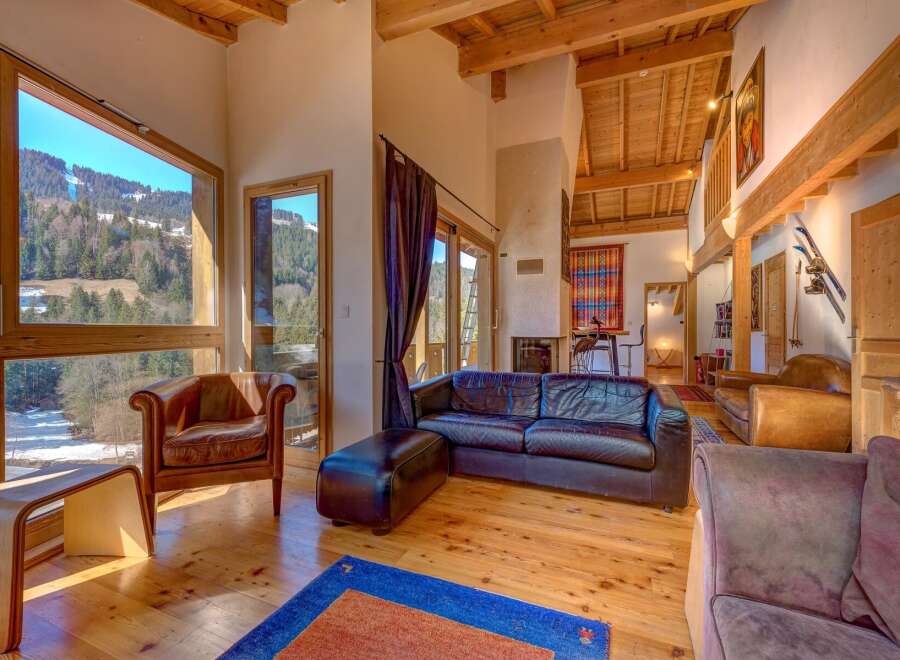 Experience luxury living in this stunning property, featuring expansive windows that frame breathtaking mountain views.