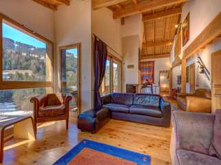 Experience luxury living in this stunning property, featuring expansive windows that frame breathtaking mountain views.