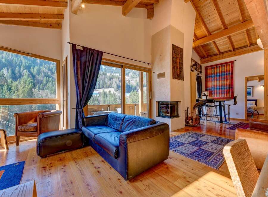 Experience luxury living in this stunning property featuring a cozy living room with a fireplace and a comfortable sofa.