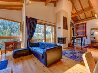 Experience luxury living in this stunning property featuring a cozy living room with a fireplace and a comfortable sofa.