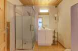 Step into this inviting bathroom, featuring a modern glass shower enclosure and a sleek vanity with a double sink.