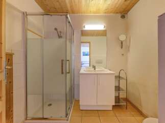 Step into this inviting bathroom, featuring a modern glass shower enclosure and a sleek vanity with a double sink.