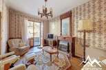 Step into this charming property featuring a cozy living room with a fireplace and elegant chandelier.