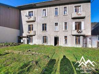 Discover this charming property, featuring a multi-story building with multiple windows and balconies, offering ample natural light and outdoor space.