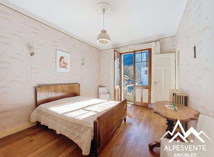 Discover this charming bedroom with a classic wooden bed and a cozy ambiance.