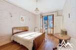 Discover this charming bedroom with a classic wooden bed and a cozy ambiance.