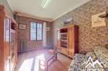 Discover the charm of this property, featuring a cozy living space with wooden floors and a unique brick-style wallpaper.