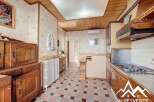 Discover the charm of this inviting kitchen, featuring classic wooden cabinetry and a cozy atmosphere.