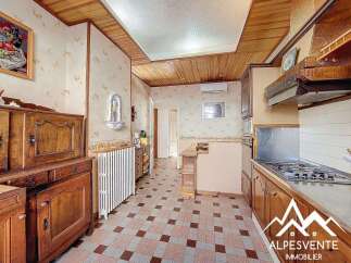 Discover the charm of this inviting kitchen, featuring classic wooden cabinetry and a cozy atmosphere.