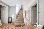 Discover the charm of this property, featuring a grand staircase and classic tiled flooring.