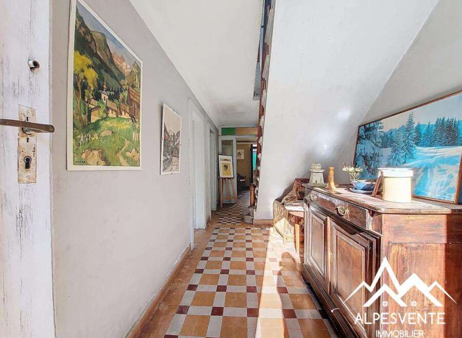 Discover the charm of this inviting hallway, featuring a classic tiled floor and a warm, welcoming atmosphere.