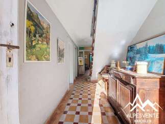 Discover the charm of this inviting hallway, featuring a classic tiled floor and a warm, welcoming atmosphere.