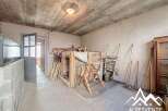 Discover the potential of this unique property! This space features a rustic interior with exposed beams and a concrete floor, perfect for renovation or creative projects.