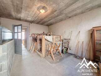 Discover the potential of this unique property! This space features a rustic interior with exposed beams and a concrete floor, perfect for renovation or creative projects.