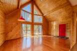 Step into this stunning cabin retreat, featuring a warm and inviting interior with beautiful wood paneling throughout.