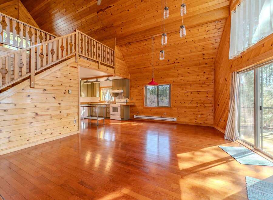 This stunning property boasts a warm and inviting interior with beautiful wooden accents throughout.