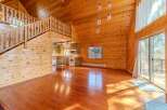 This stunning property boasts a warm and inviting interior with beautiful wooden accents throughout.
