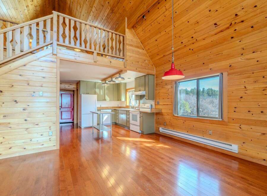 This stunning property boasts a unique architectural design with exposed wooden beams and a loft area, creating a warm and inviting atmosphere.