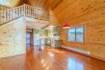 This stunning property boasts a unique architectural design with exposed wooden beams and a loft area, creating a warm and inviting atmosphere.
