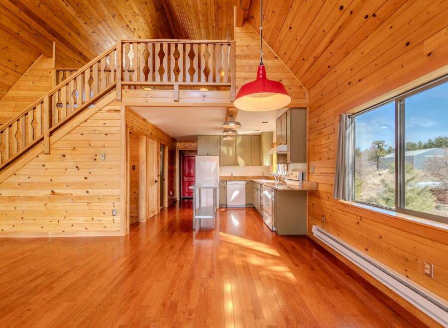Step into this stunning home featuring a warm and inviting interior with beautiful wooden accents throughout.