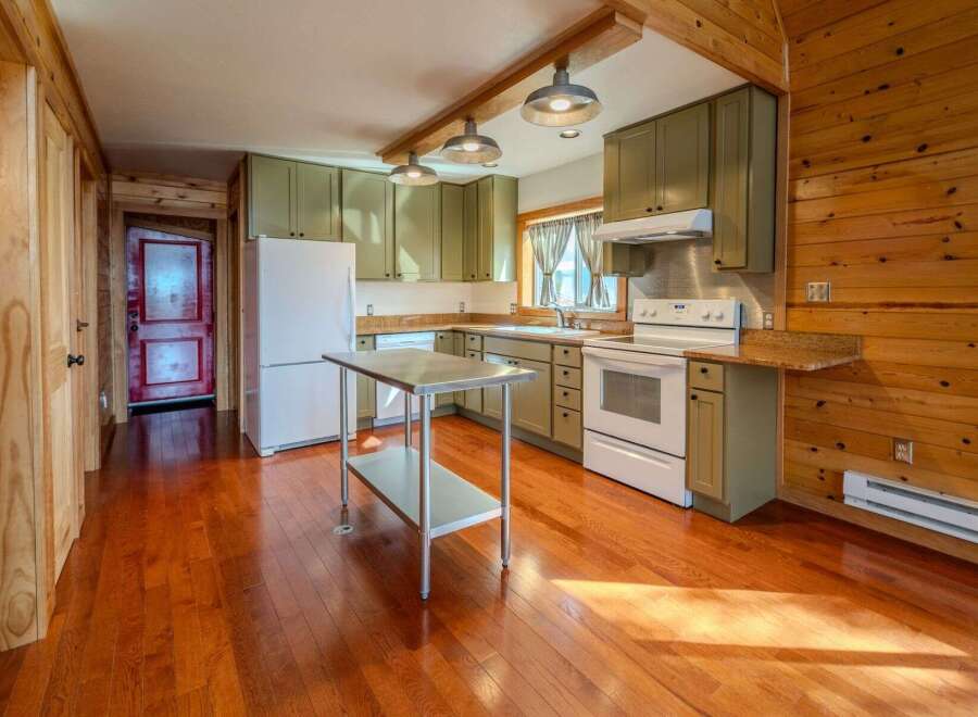 Step into this charming kitchen with its warm, inviting ambiance.
