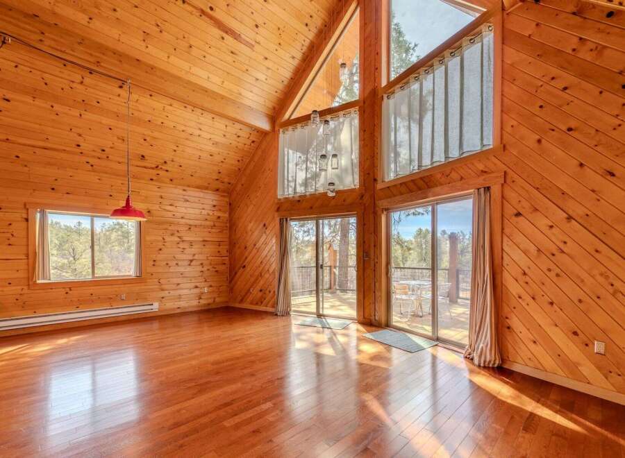 Step into this stunning cabin with its warm, inviting wood paneling and soaring ceilings.