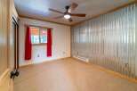 This inviting bedroom features a unique corrugated metal accent wall, adding a touch of industrial charm.