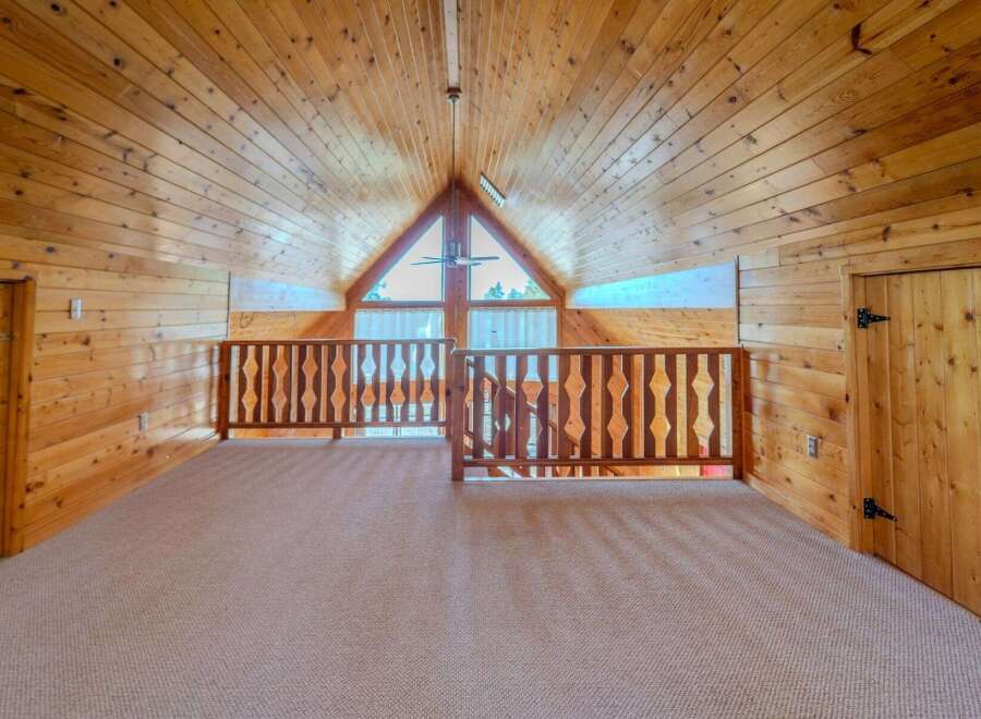 Step into this stunning loft space, showcasing a warm, inviting ambiance with its all-wood construction.