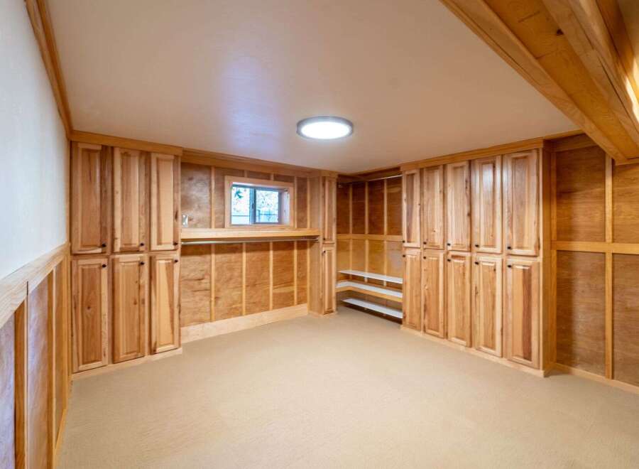 This stunning property boasts a beautifully designed interior with custom cabinetry and ample storage space.