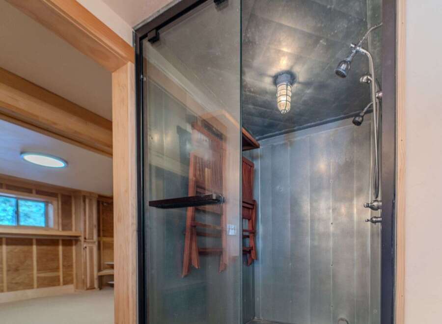 Step into a unique and stylish shower space! This modern bathroom features a sleek glass enclosure and industrial-inspired design.