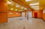 This spacious garage offers ample room for vehicles and storage.