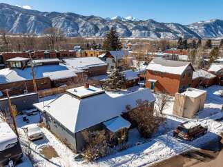 Nestled in a picturesque winter landscape, this charming property offers a cozy retreat.