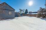Discover the charm of this property, featuring a spacious backyard blanketed in fresh snow.