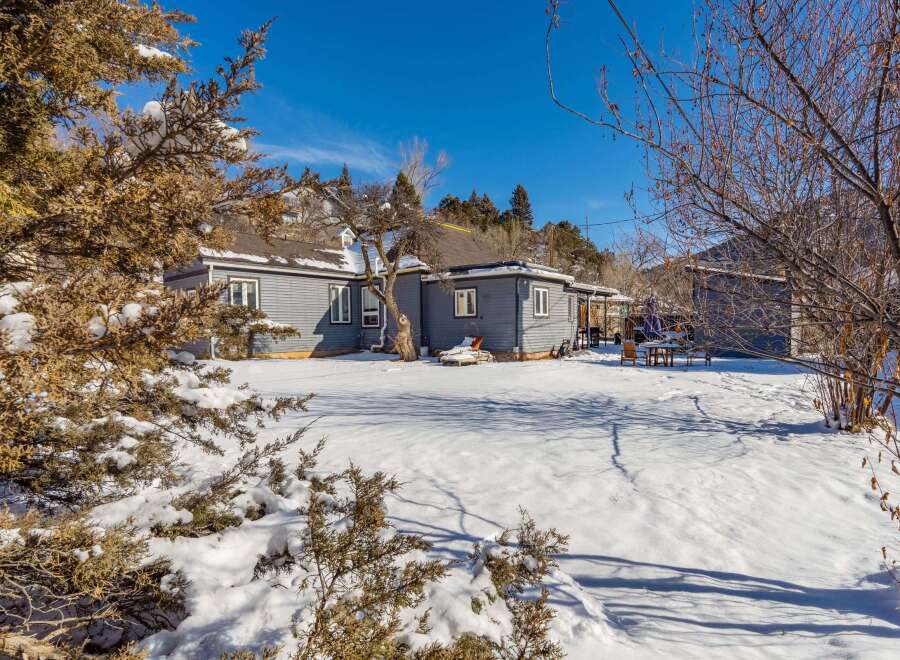 Nestled in a serene winter landscape, this charming property offers a tranquil retreat.