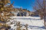 Nestled in a serene winter landscape, this charming property offers a tranquil retreat.