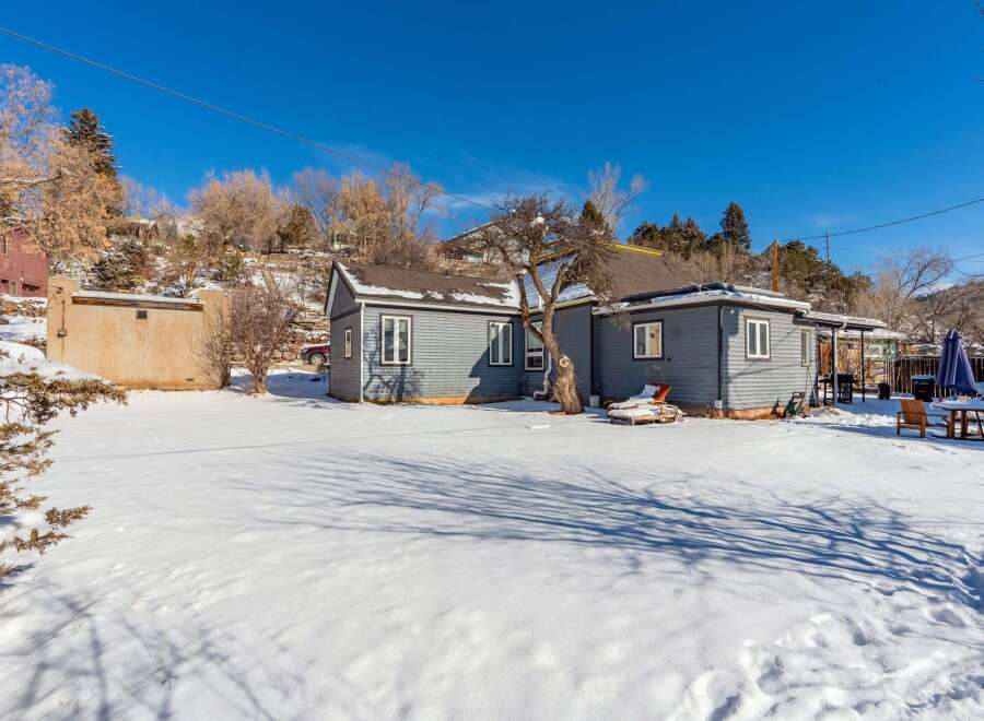 This charming property features a cozy home with a beautiful snow-covered yard, perfect for enjoying the winter season.