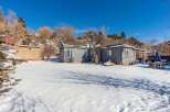 This charming property features a cozy home with a beautiful snow-covered yard, perfect for enjoying the winter season.