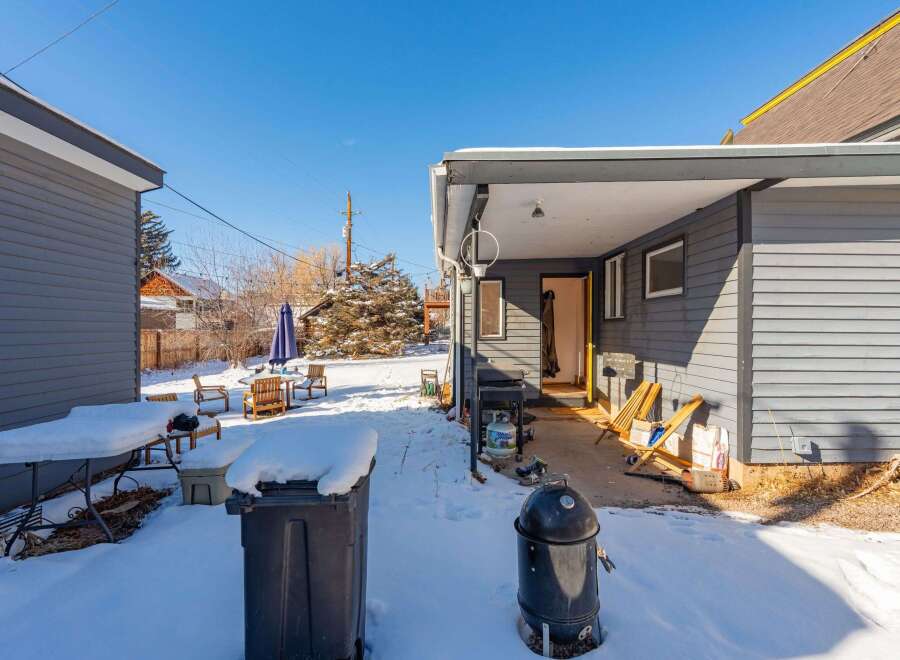 Enjoy the winter wonderland in this charming property! This home features a cozy outdoor space, perfect for enjoying the snowy landscape.