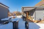 Enjoy the winter wonderland in this charming property! This home features a cozy outdoor space, perfect for enjoying the snowy landscape.