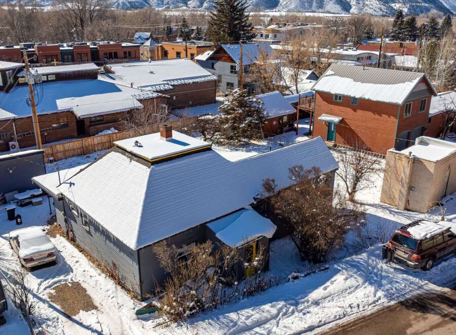 This charming property boasts a snow-covered roof and a cozy exterior, perfect for a winter retreat.