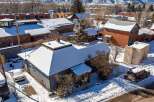 This charming property boasts a snow-covered roof and a cozy exterior, perfect for a winter retreat.