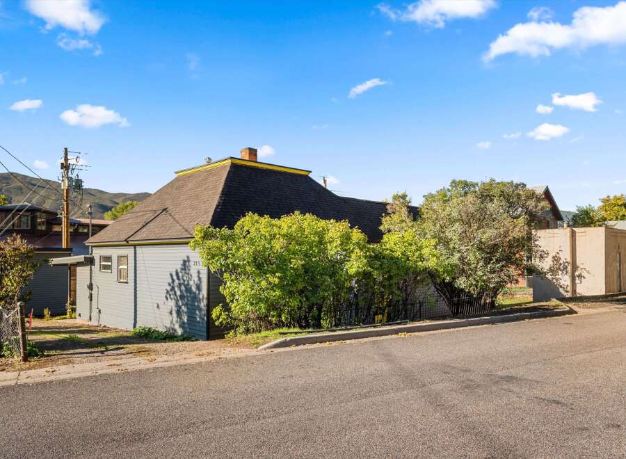 Charming home with a unique architectural design, featuring a distinctive roof and exterior.