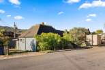 Charming home with a unique architectural design, featuring a distinctive roof and exterior.