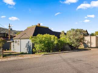 Charming home with a unique architectural design, featuring a distinctive roof and exterior.
