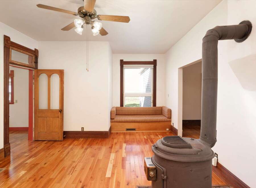 Step into this charming home featuring beautiful hardwood floors and a cozy built-in bench seat.