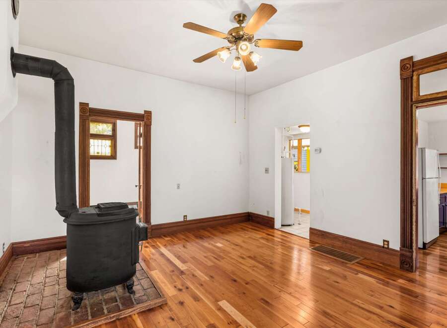 Step back in time with this charming property featuring original hardwood floors and a cozy wood-burning stove.