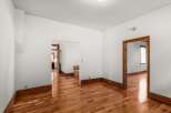 Step into this inviting space with gleaming hardwood floors and crisp white walls.